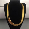 A 8mm-wide gold-plated men's chain necklace—a classic herringbone style designed to sit at the collarbone.