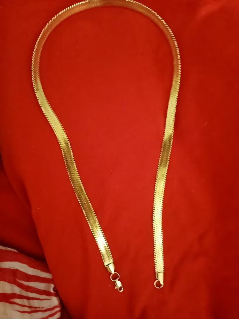 A 8mm-wide gold-plated men's chain necklace—a classic herringbone style designed to sit at the collarbone.